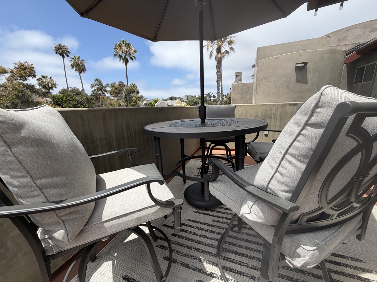 The studio's sunlit private balcony with seating where parents can relax during lessons