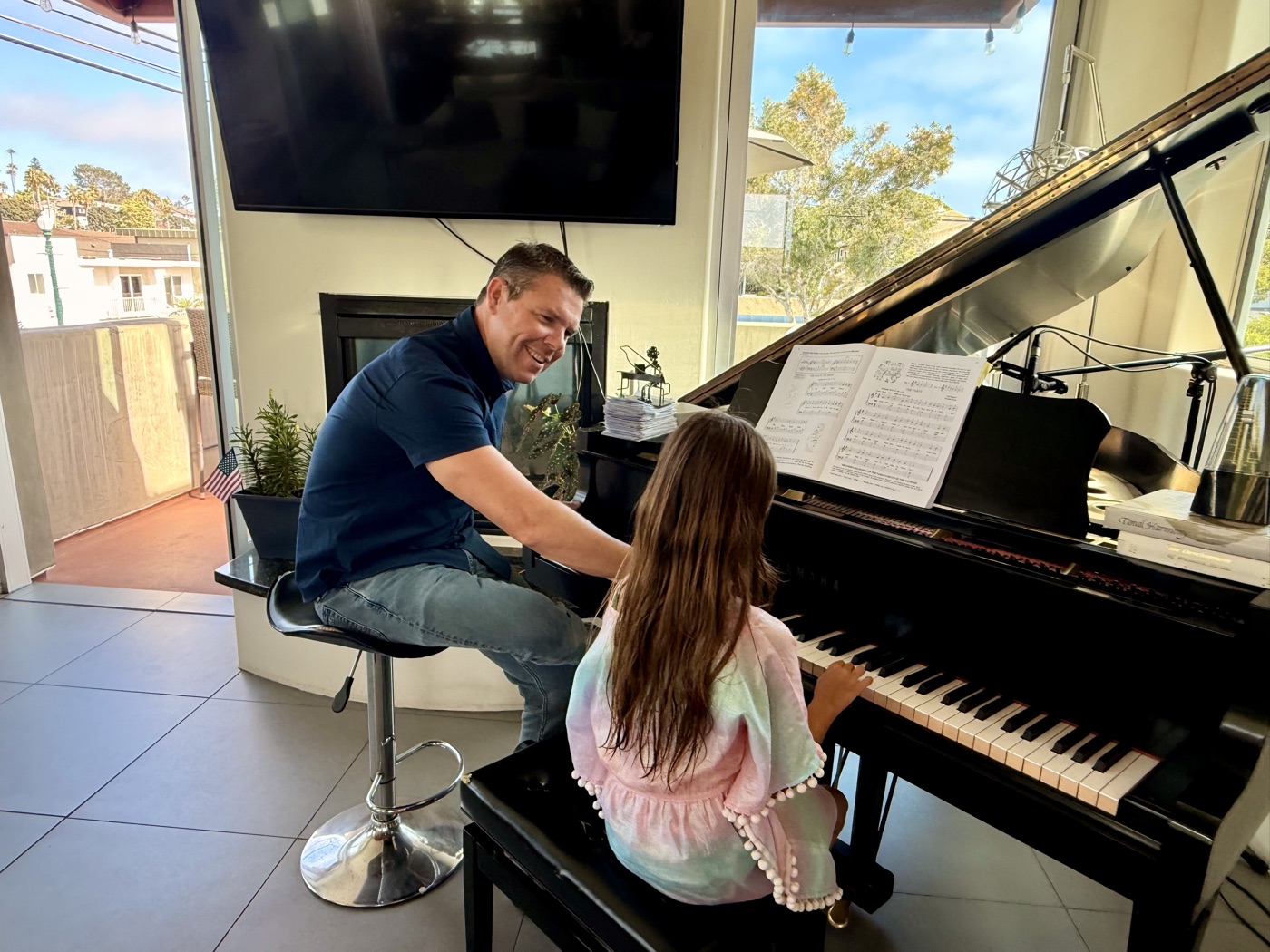 Brian Wahlstrom teaching a piano student at the grand piano in his downtown Encinitas studio